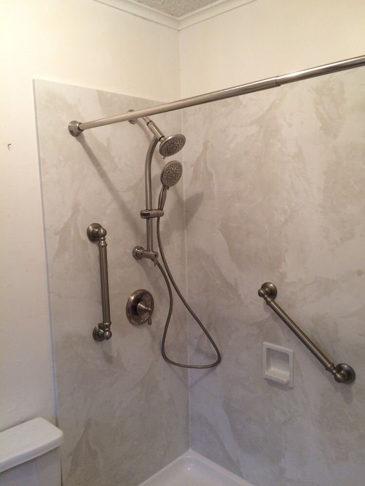 Barrier free shower with grab bars and a handheld sprayer