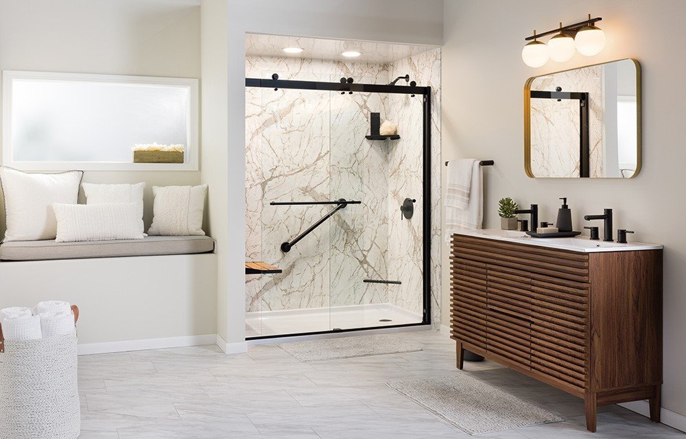 Walk in shower with sliding glass and a built in bench